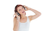 Casual woman enjoying music through headphones