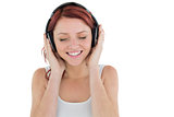 Beautiful woman enjoying music through headphones