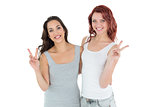 Portrait of two young female friends gesturing peace sign