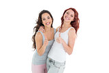 Portrait of two young female friends gesturing thumbs up
