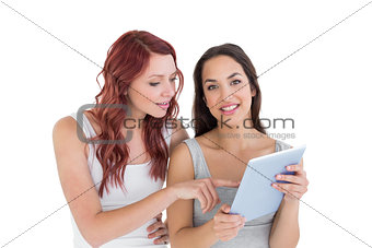 Two casual young female friends with digital tablet