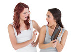 Two shocked young female friends with digital tablet