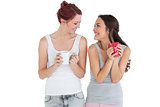 Two smiling young female friends with coffee cups