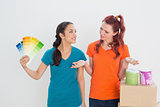 Confused friends choosing color for painting a room