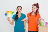 Confused friends choosing color for painting a room
