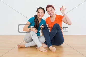 Friends with house keys sitting on the floor