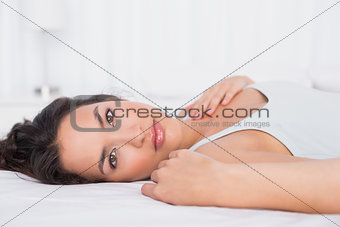 Pretty young woman relaxing in bed