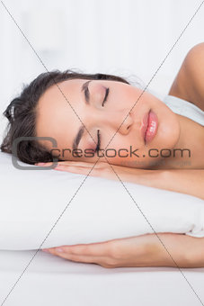 Close-up of a pretty woman sleeping with eyes closed in bed