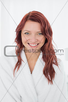 Portrait of a happy young female in bathrobe