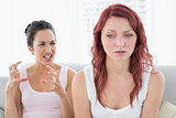 Angry female friends having an argument in the living room