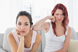 Unhappy female friends not talking after argument at home