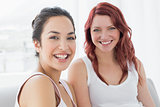 Portrait of two beautiful young female friends smiling