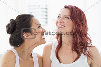 Close-up of two beautiful young female friends smiling