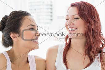 Close-up of two beautiful young female friends smiling