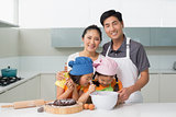 Family of four preparing cookies in kitchen