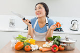 Thoughtful woman chopping vegetables in kitchen