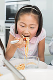 Close-up of a happy young kid enjoying spaghetti lunch