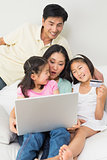 Family of four doing online shopping