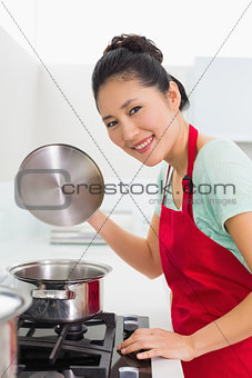 Side view portrait of a woman preparing food in kitchen