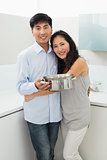 Young woman embracing man in kitchen