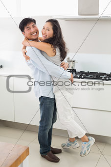 Side view portrait of a young couple in kitchen