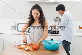 Young couple preparing food together in kitchen