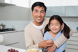 Portrait of a happy father with daughter in kitchen