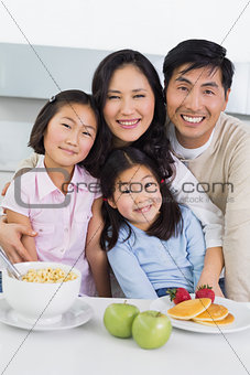 Family of four having breakfast in the kitchen