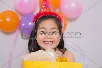 Little girl with gift at her birthday party