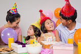 Family with cake and gifts at a birthday party