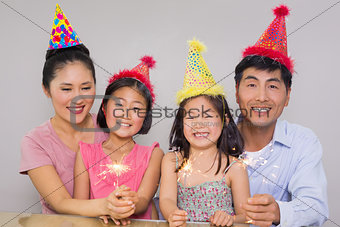 Family of four playing with firecrackers at a birthday party