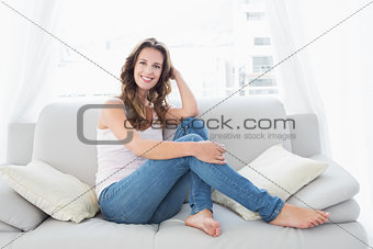 Smiling young woman sitting in living room