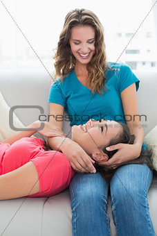 Female resting on friends lap in the living room