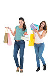 Two happy young female friends with shopping bags