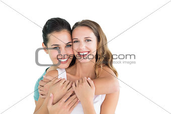 Happy female embracing her friend from behind