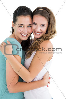Side view portrait of a female embracing her friend