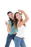 Two cheerful young female friends dancing