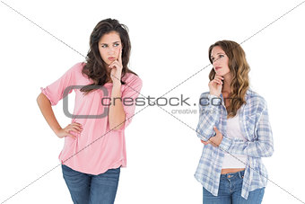 Two thoughtful casual young female friends