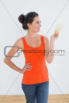 Woman choosing color for painting a room