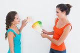 Female friends choosing color for painting a room