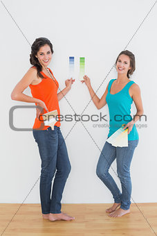 Female friends choosing color in a new house