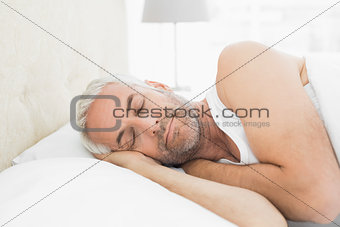 Close-up of a mature man sleeping in bed
