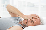 Mature man sleeping in bed