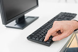 Hand using computer keyboard