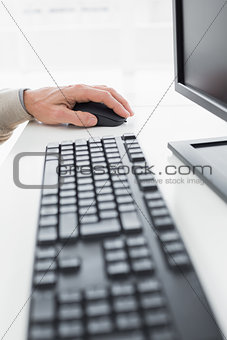 Close-up of a businessmans hand using computer mouse