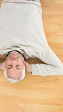 Overhead view of a man sleeping on parquet floor