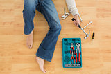 Man lying with several tools on parquet floor
