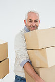 Portrait of a smiling mature man carrying boxes