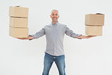 Portrait of a smiling mature man carrying boxes
