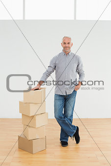 Mature man with boxes in a new house